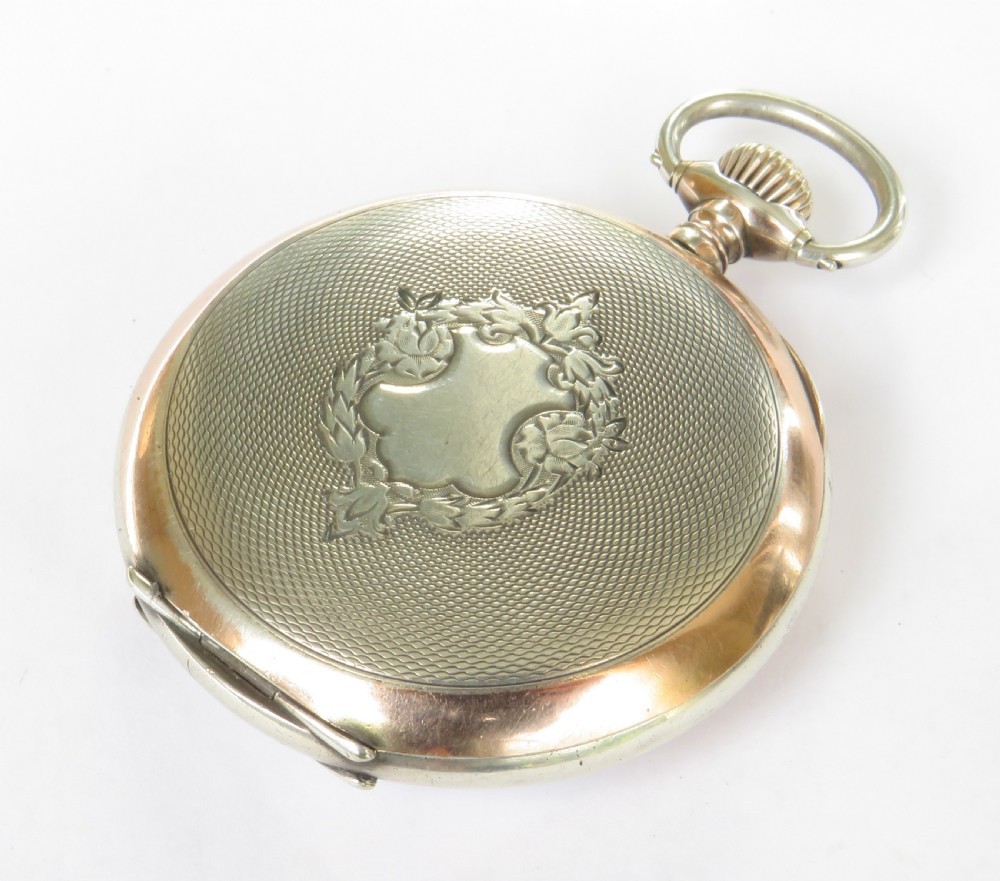 An antique open-face silver pocket watch featuring a white enamel dial with black Arabic numerals and a subsidiary seconds dial at six oclock. View VI