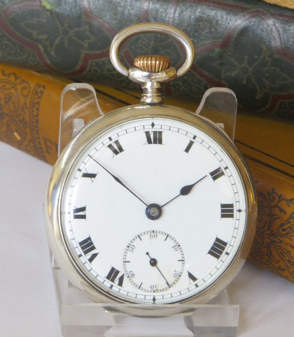 An antique open-face silver pocket watch featuring a white enamel dial with black Roman numerals and a small sub-seconds dial. View II