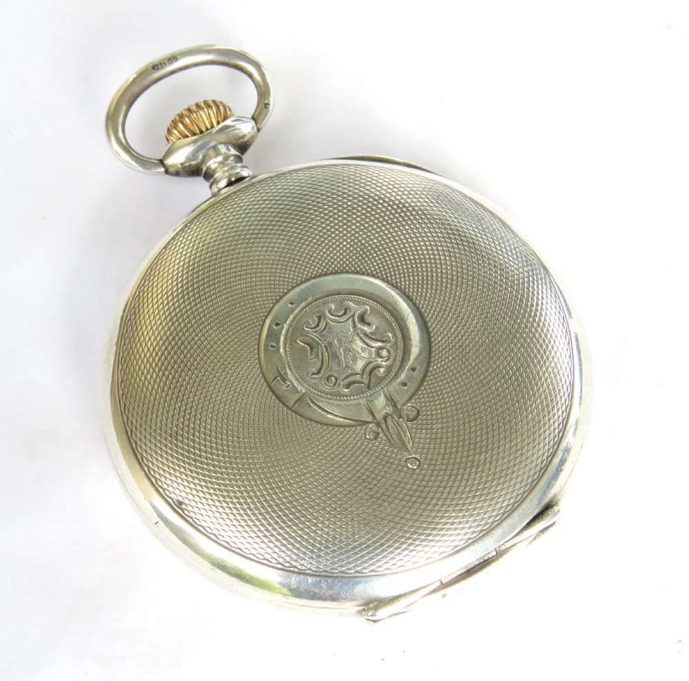An antique open-face silver pocket watch featuring a white enamel dial with black Roman numerals and a small sub-seconds dial. View V
