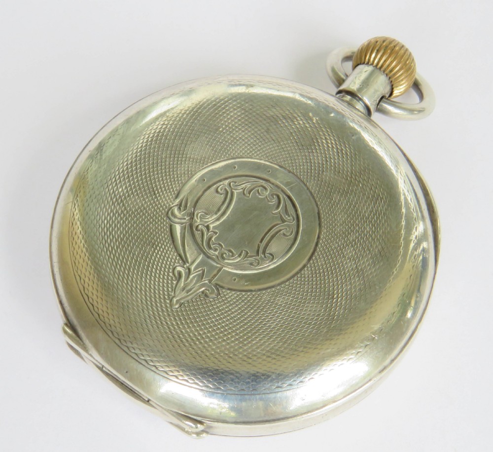 An open-face antique silver pocket watch featuring a white enamel dial with black Roman numerals and a subsidiary seconds sub-dial. View V