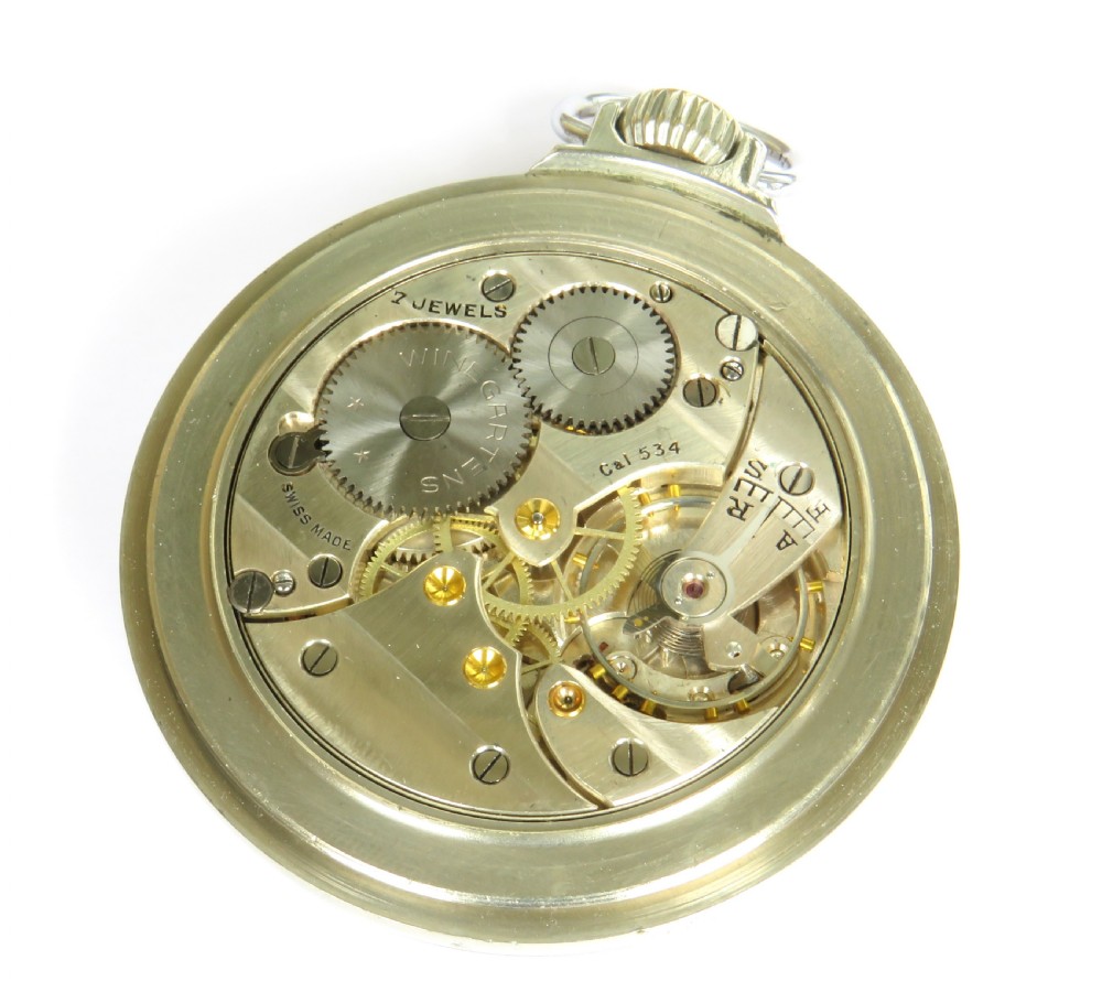 An open-face pocket watch featuring a white enamel dial with black Roman numerals, blued steel hands, a subsidiary seconds dial, and a silver-toned metal case with a gold-coloured winding crown. View III