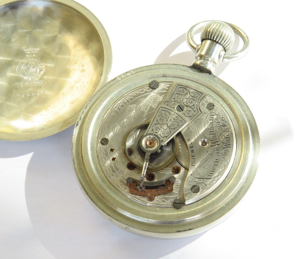 An antique silver-tone open-face pocket watch featuring a white enamel dial with black Roman numerals and a subsidiary seconds dial. View III