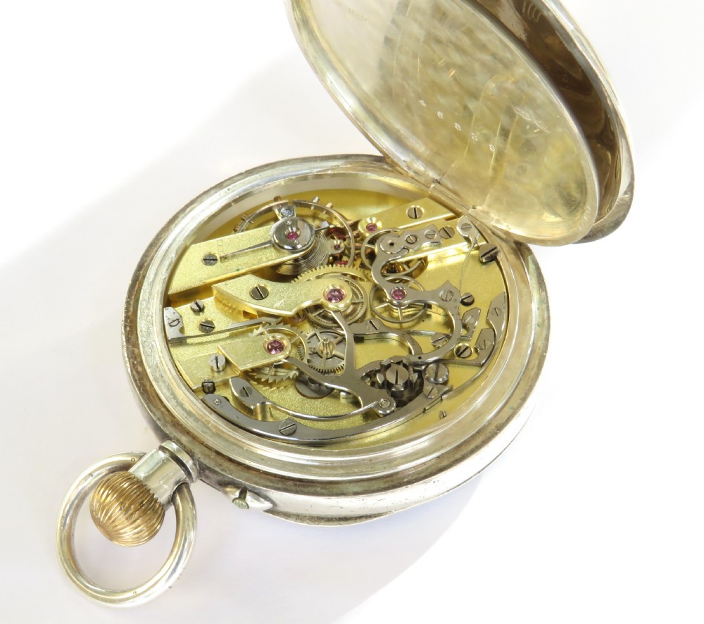 An antique silver open-face chronograph pocket watch featuring a white enamel dial with Roman numerals, two sub-dials, and a gold crown. View IV