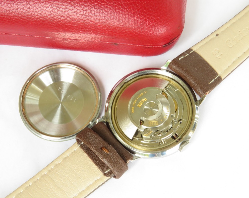 A 1960s mens Rone automatic wristwatch featuring a champagne dial, gold-tone casing, and a brown leather strap. View III