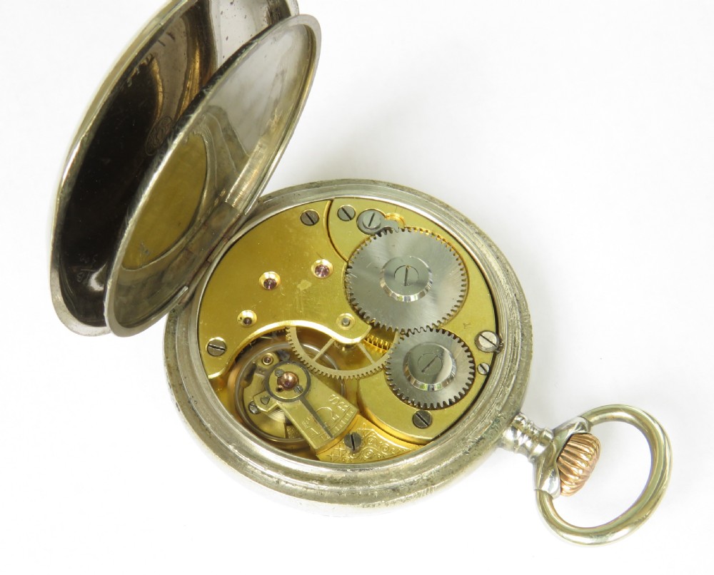 An open-face antique Omega pocket watch with a white enamel dial, black Arabic numerals, ornate hands, and a silver-toned metal case. View IV