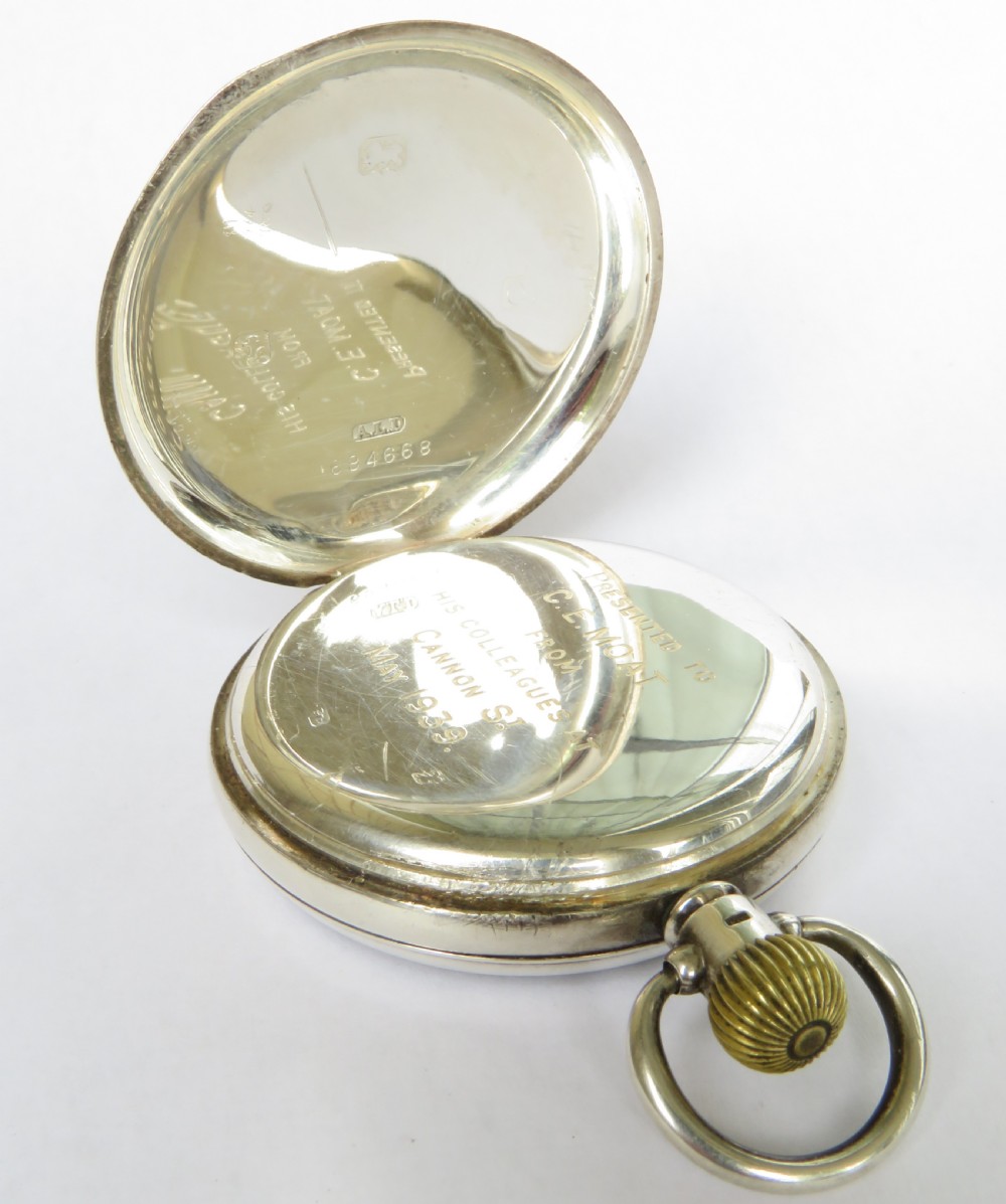 A 1930s open-face pocket watch featuring a silver case, white enamel dial with black Arabic numerals, and a subsidiary seconds dial at six oclock. View III