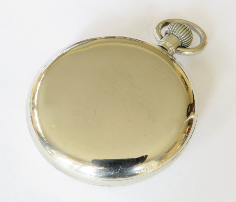 An open-face 1930s Cortebert Swiss pocket watch with a white enamel dial, black Arabic numerals, sub-seconds register, and a polished silver-toned metal case. View IV