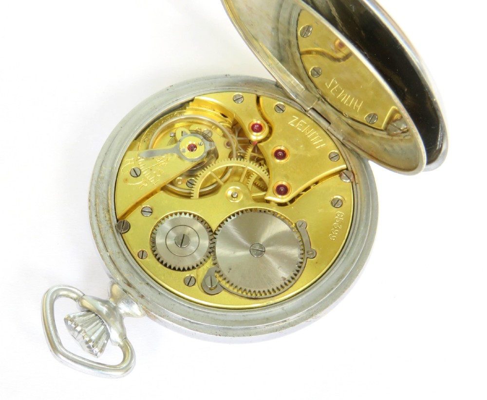 An open-face 1930s Zenith pocket watch featuring a white enamel dial with black Art Deco Arabic numerals, subsidiary seconds dial, and silver-toned metal case. View IV