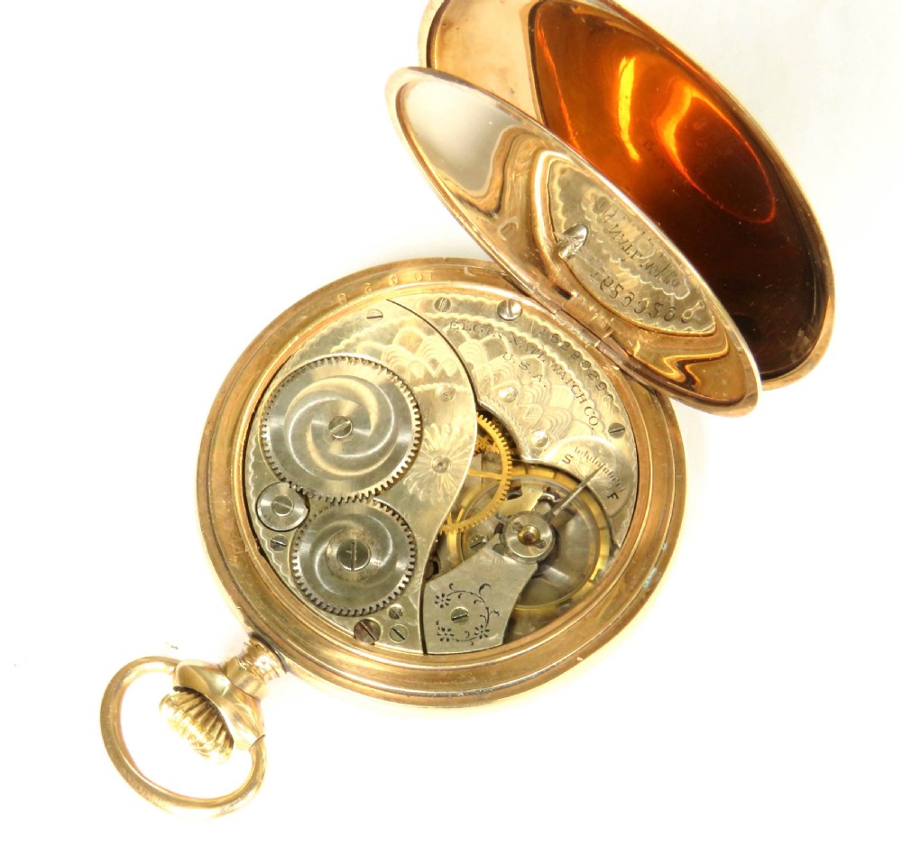 An Edwardian open-face gold-filled Elgin pocket watch featuring a white enamel dial with black Arabic numerals and a subsidiary seconds dial. View IV