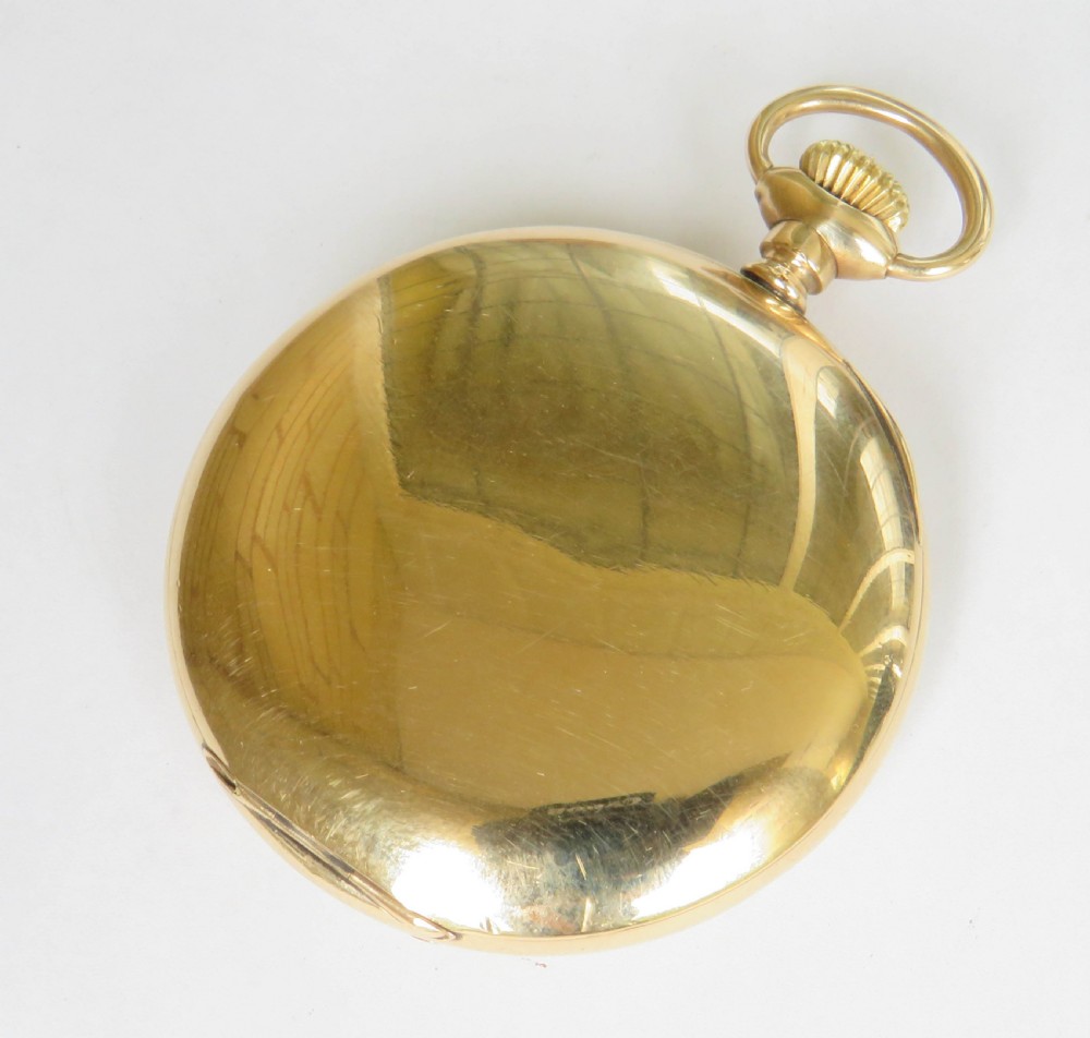 An Edwardian open-face gold-filled Elgin pocket watch featuring a white enamel dial with black Arabic numerals and a subsidiary seconds dial. View V