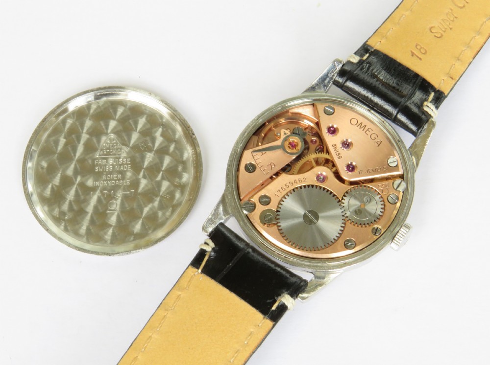 A 1960s gents Omega wristwatch with a round stainless steel case, a cream dial featuring baton markers and a sub-seconds dial, paired with a stitched black leather strap. View III