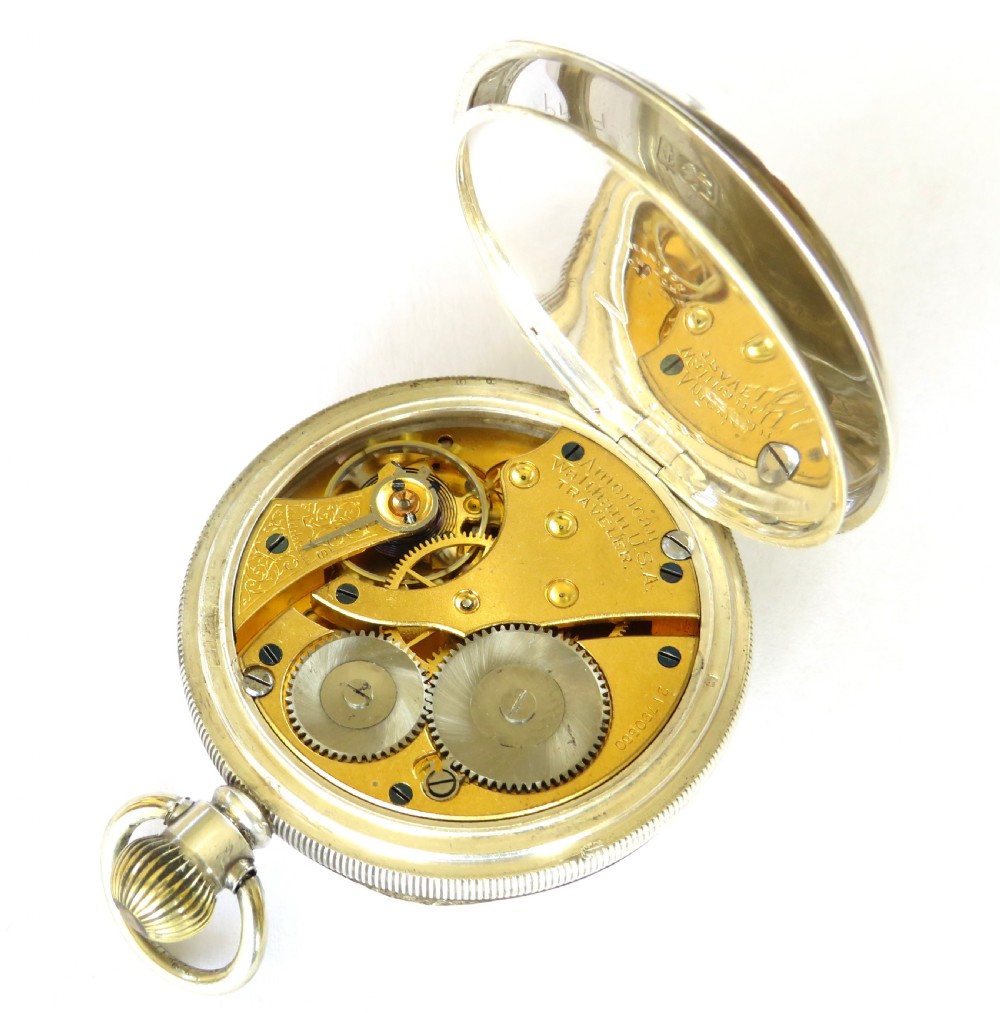 An open-face antique silver pocket watch featuring a white enamel dial, black Arabic numerals, and a subsidiary seconds dial at six oclock. View IV