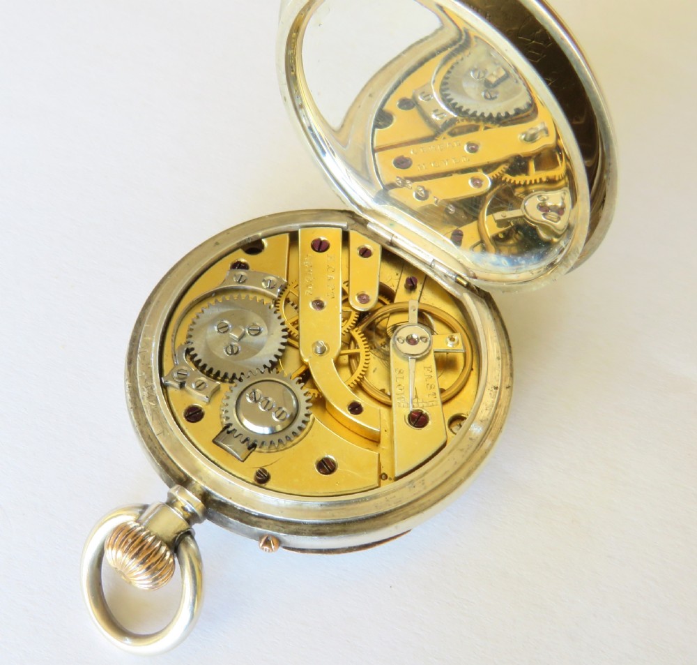 An antique Henry Capt silver open-face pocket watch featuring a white enamel dial with black Roman numerals and a rose gold winding crown. View V