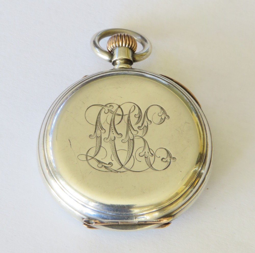 An antique Henry Capt silver open-face pocket watch featuring a white enamel dial with black Roman numerals and a rose gold winding crown. View VI