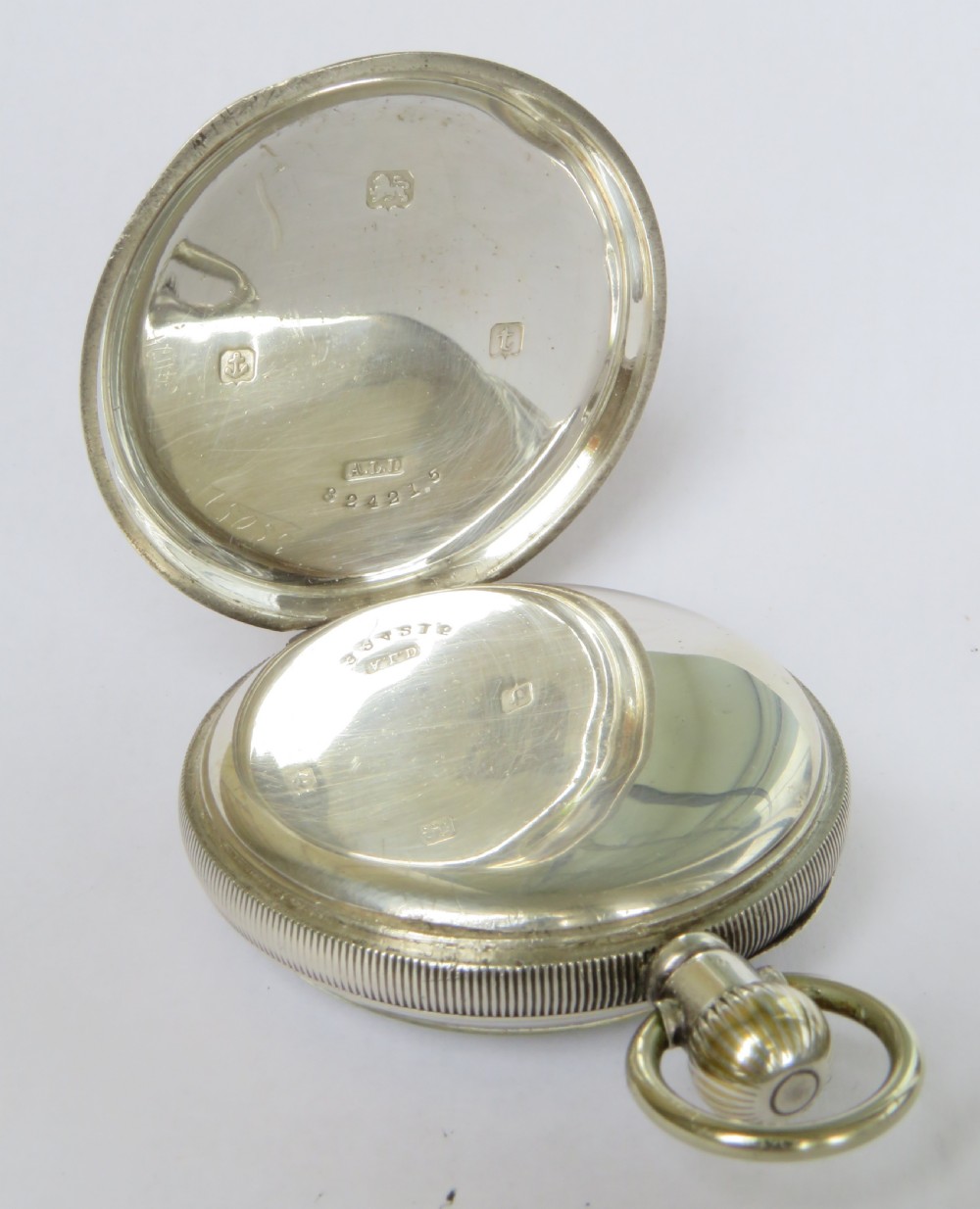 An antique open-face silver pocket watch displaying a white enamel dial with black Roman numerals and a small seconds sub-dial at six oclock. View III