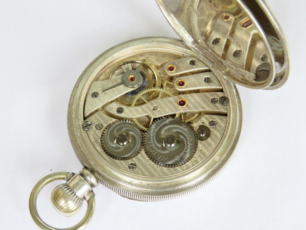 An antique open-face silver pocket watch displaying a white enamel dial with black Roman numerals and a small seconds sub-dial at six oclock. View IV