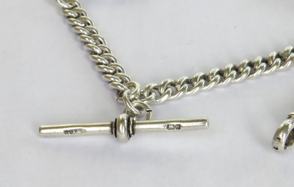 A sterling silver curb link pocket watch chain featuring a T-bar, swivel clasp, and an engraved shield-shaped darts medallion fob. View IV