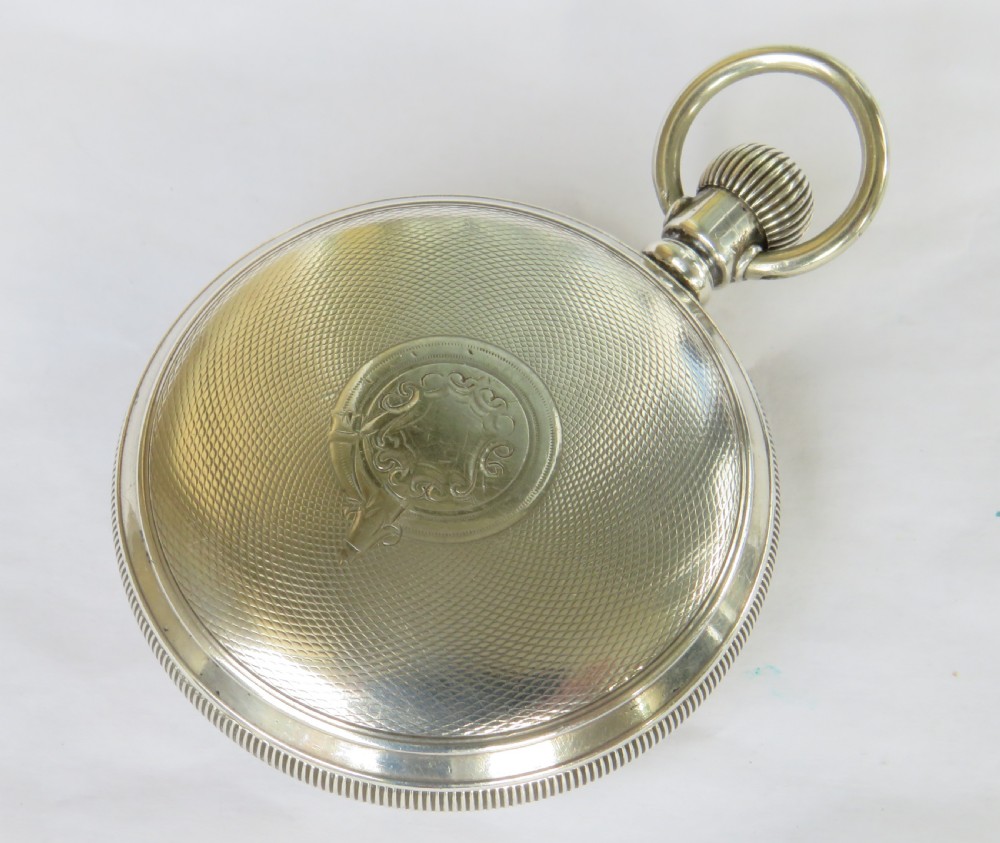 An antique open-face silver pocket watch with a white dial featuring Roman numerals, spade hands, and a subsidiary seconds dial. View IV
