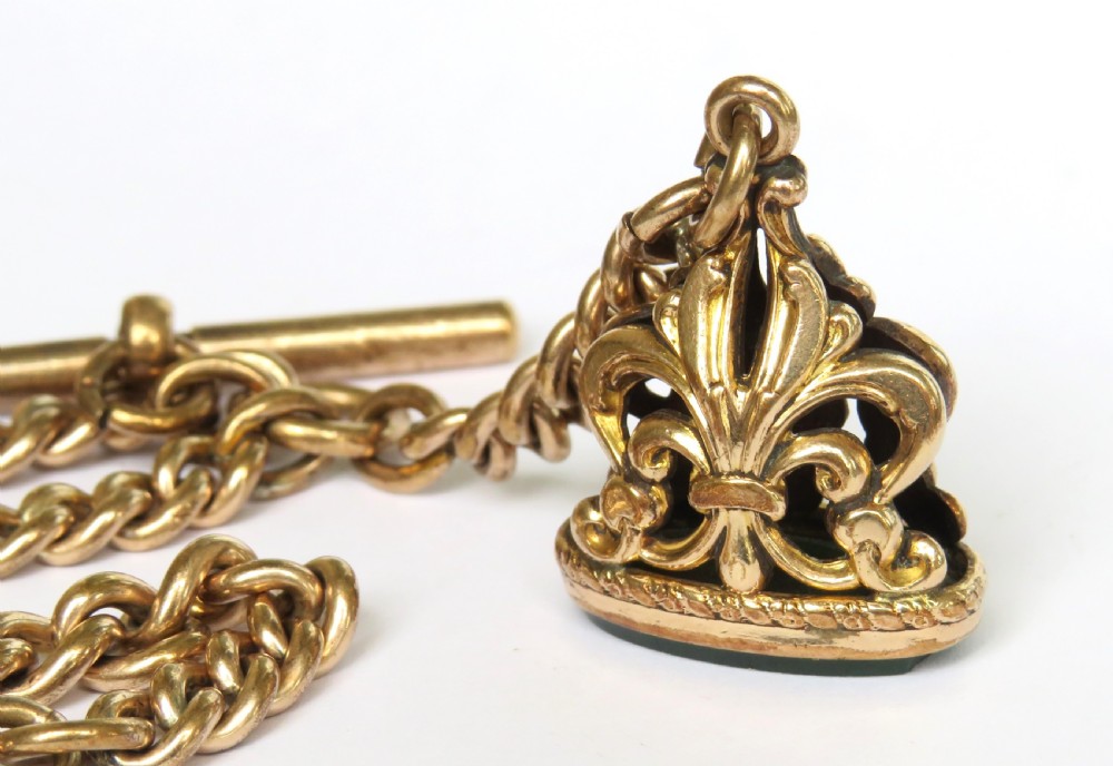 An antique rolled gold curb link Albert watch chain featuring a T-bar, swivel clasp, bolt ring, and a suspended fob with a green oval stone intaglio. View II