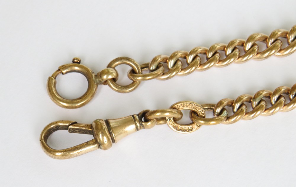 An antique rolled gold curb link Albert watch chain featuring a T-bar, swivel clasp, bolt ring, and a suspended fob with a green oval stone intaglio. View V