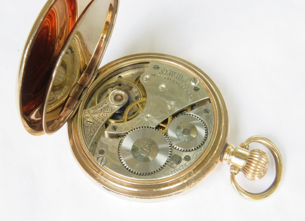 An open gold full hunter pocket watch displaying a white enamel dial with black Roman numerals and a small seconds subdial. View III