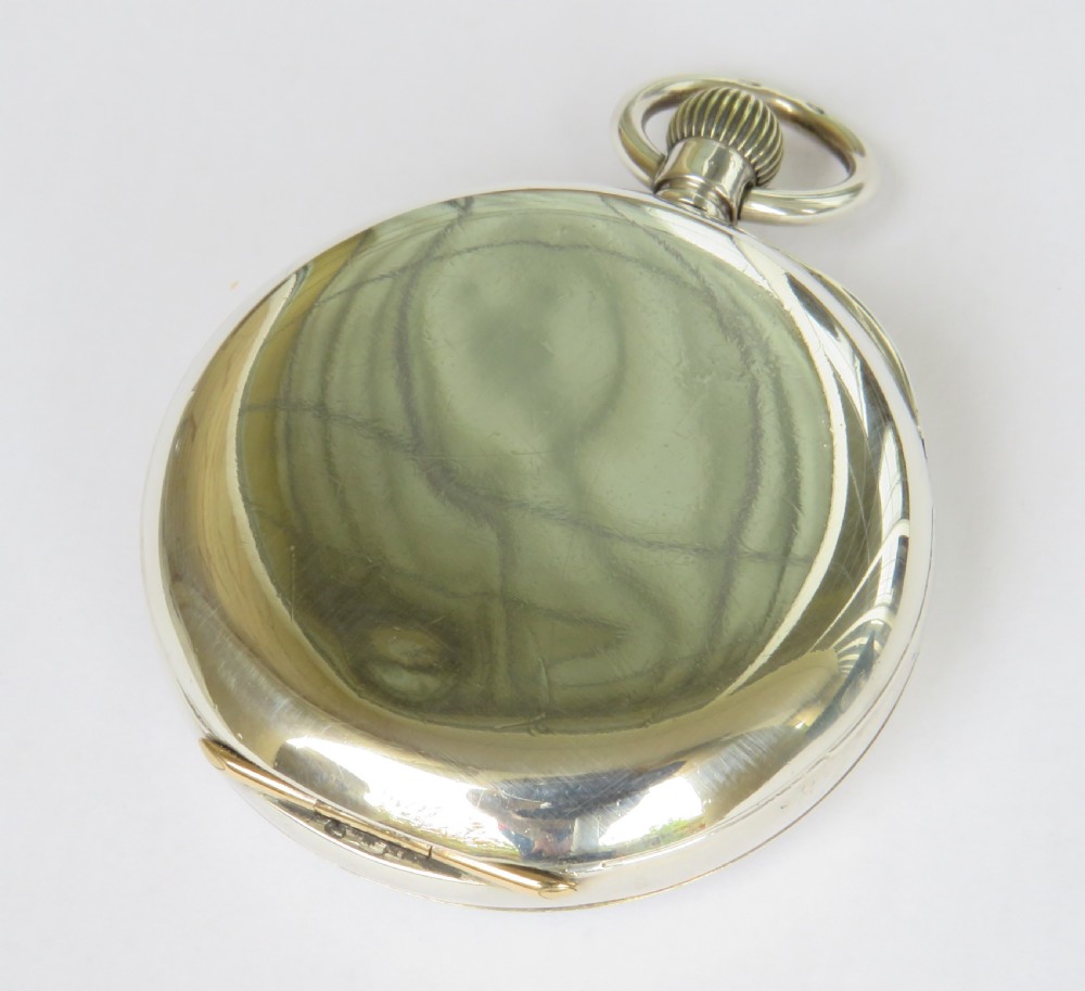 An open-face antique silver pocket watch featuring a white enamel dial with black Roman numerals and a subsidiary seconds dial. View V