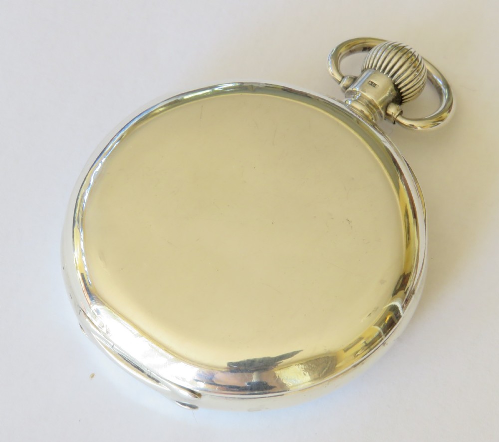 An open-face silver pocket watch by J.W. Benson featuring a white enamel dial with black Roman numerals and a subsidiary seconds dial. View VI