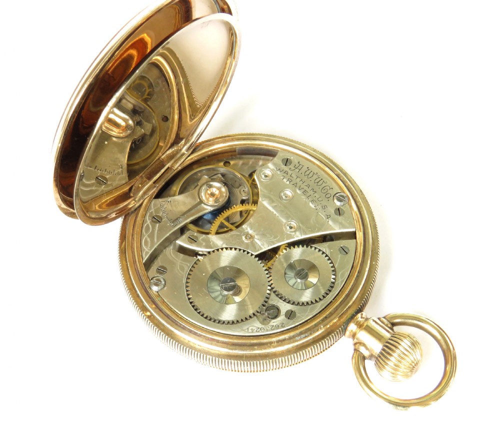 An open antique gold-toned Waltham full hunter pocket watch displaying a white enamel dial with black Roman numerals and a subsidiary seconds dial. View IV