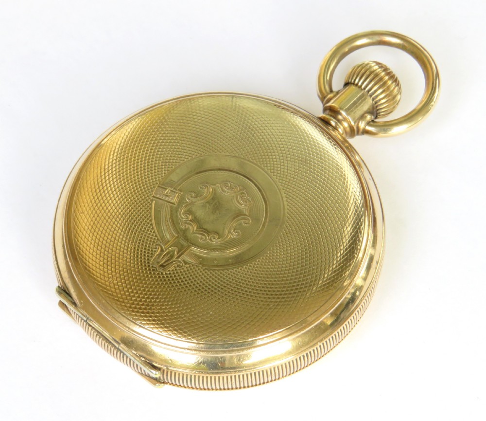 An open antique gold-toned Waltham full hunter pocket watch displaying a white enamel dial with black Roman numerals and a subsidiary seconds dial. View V