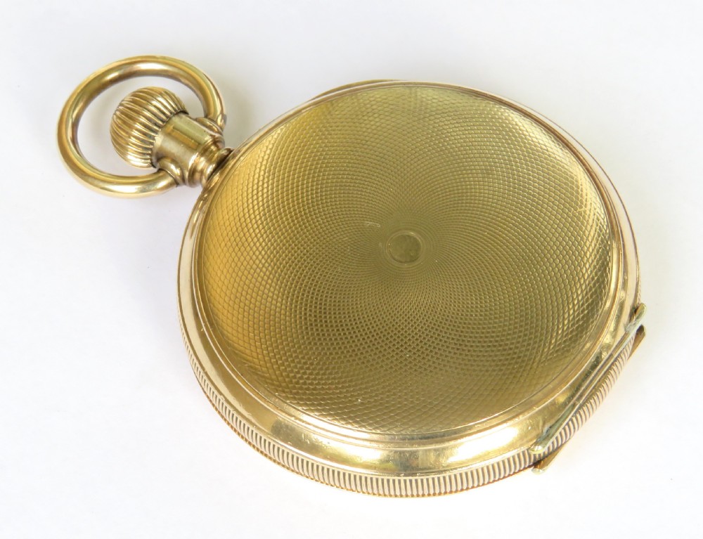 An open antique gold-toned Waltham full hunter pocket watch displaying a white enamel dial with black Roman numerals and a subsidiary seconds dial. View VI