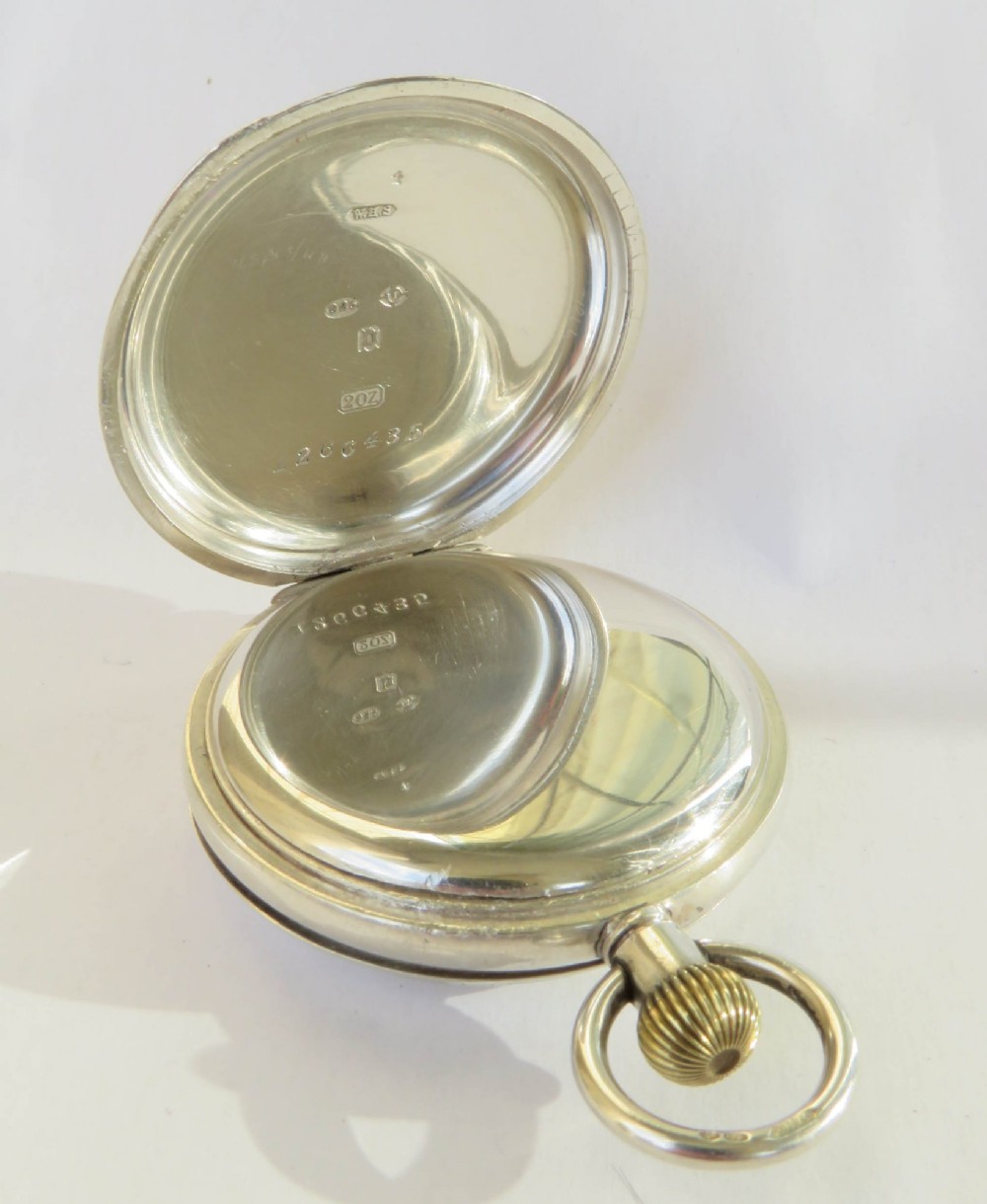 An open antique silver full hunter pocket watch displaying a white enamel dial with black Roman numerals and a subsidiary seconds dial. View III