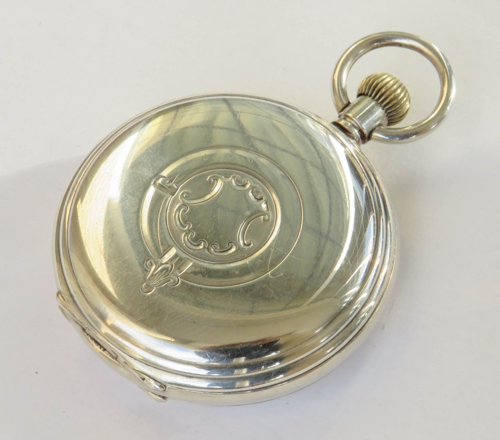 An open antique silver full hunter pocket watch displaying a white enamel dial with black Roman numerals and a subsidiary seconds dial. View V
