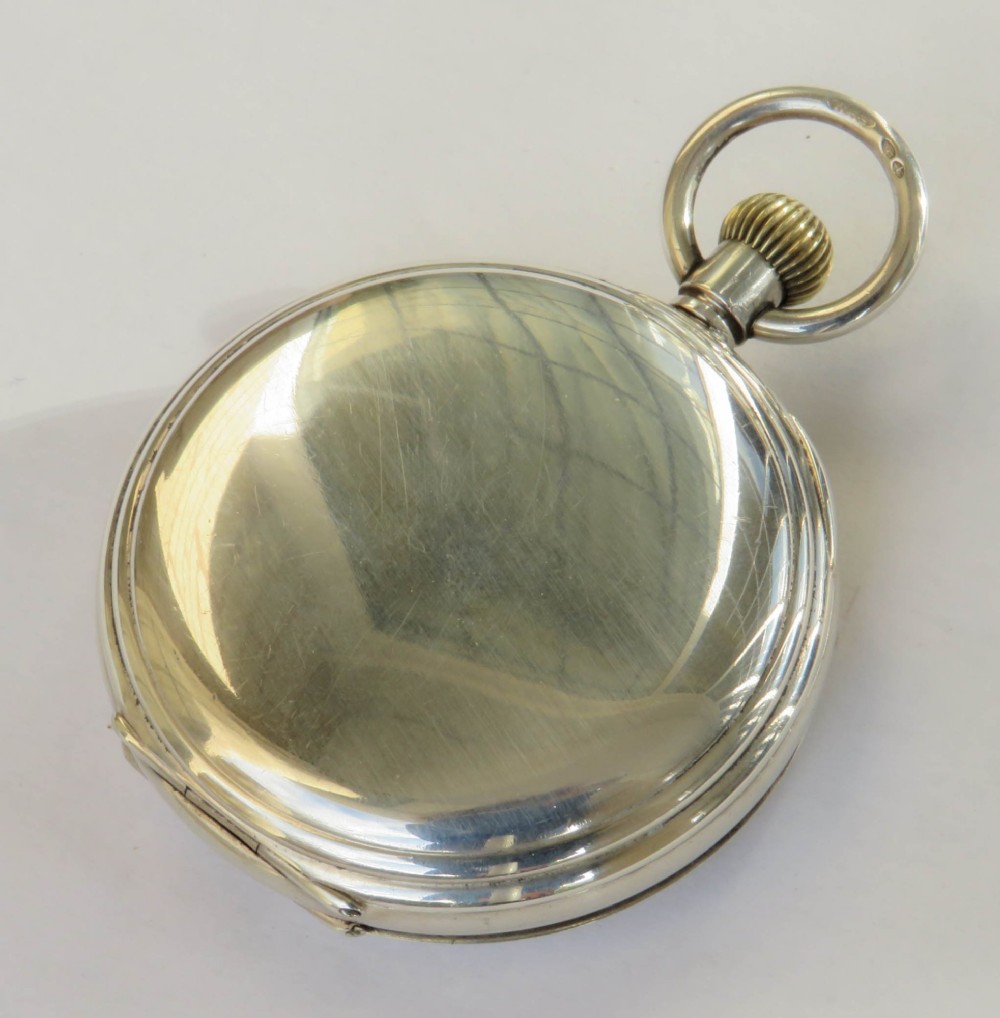 An open antique silver full hunter pocket watch displaying a white enamel dial with black Roman numerals and a subsidiary seconds dial. View VI