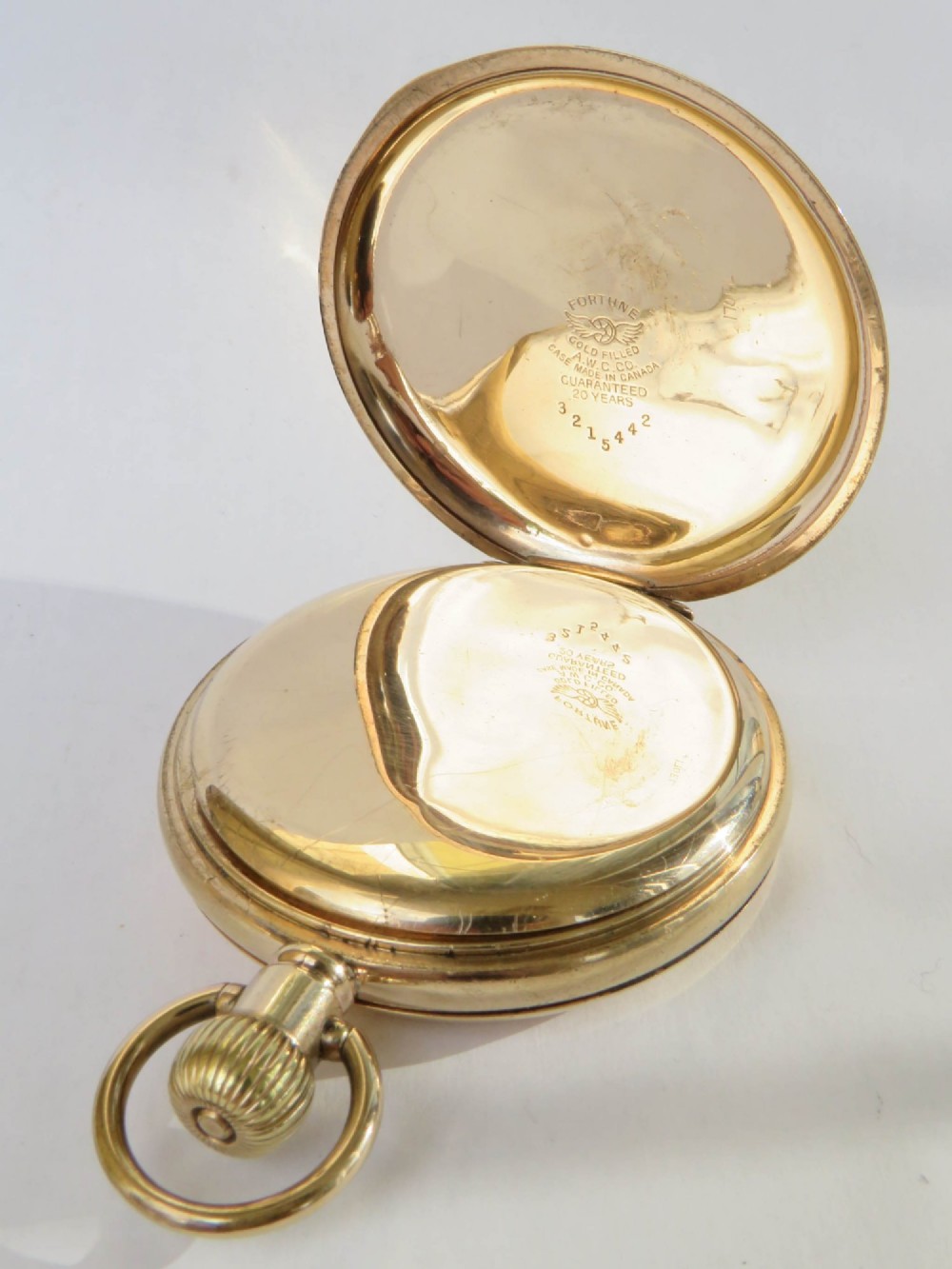 A 1930s gold full hunter pocket watch shown open to display a white enamel dial with Roman numerals and a subsidiary seconds dial. View III