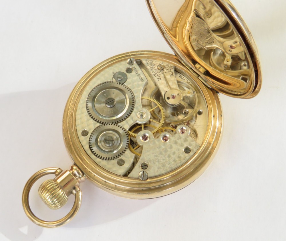 A 1930s gold full hunter pocket watch shown open to display a white enamel dial with Roman numerals and a subsidiary seconds dial. View IV