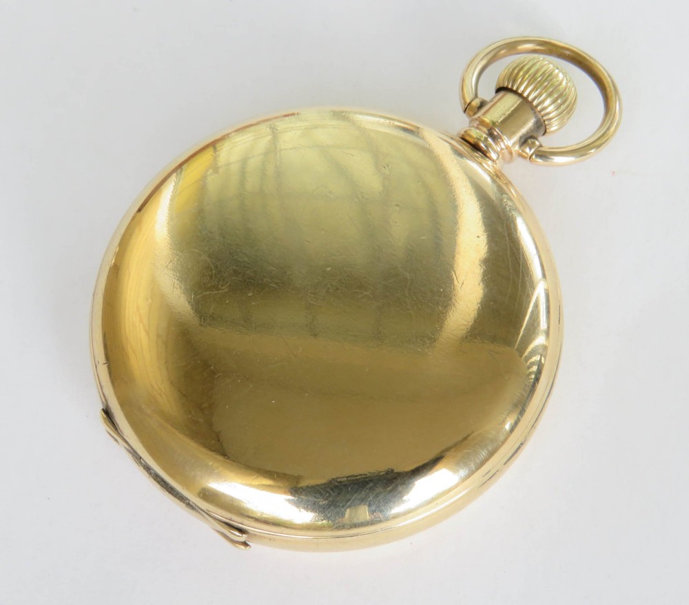 A 1930s gold full hunter pocket watch shown open to display a white enamel dial with Roman numerals and a subsidiary seconds dial. View V
