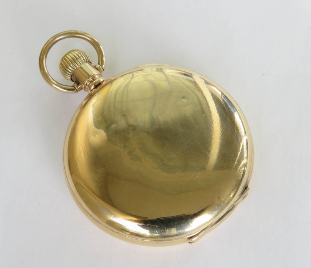 A 1930s gold full hunter pocket watch shown open to display a white enamel dial with Roman numerals and a subsidiary seconds dial. View VI