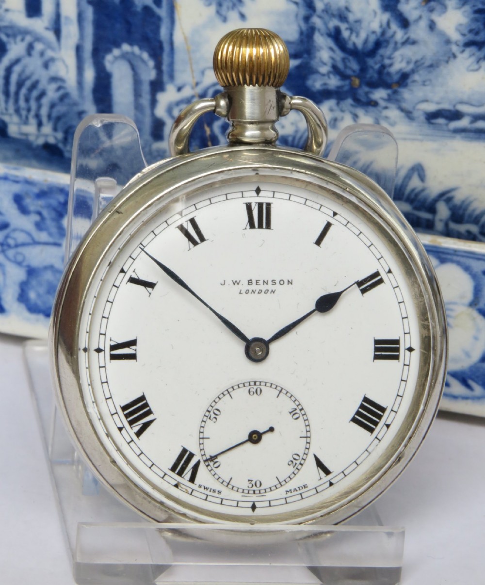 An antique open-face silver pocket watch featuring a white enamel dial with black Roman numerals and a subsidiary seconds dial. View II