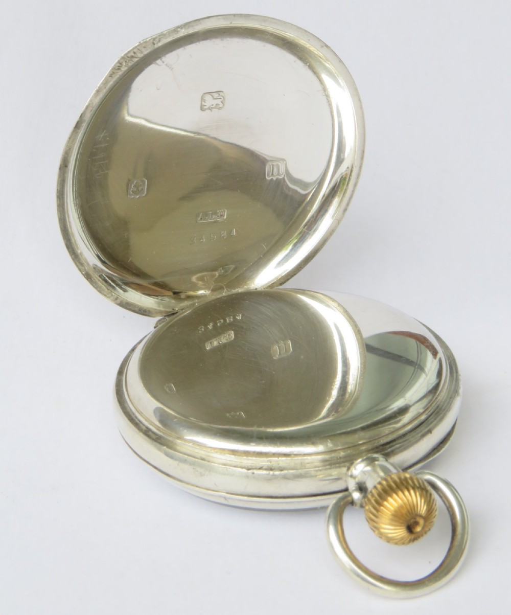 An antique open-face silver pocket watch featuring a white enamel dial with black Roman numerals and a subsidiary seconds dial. View III