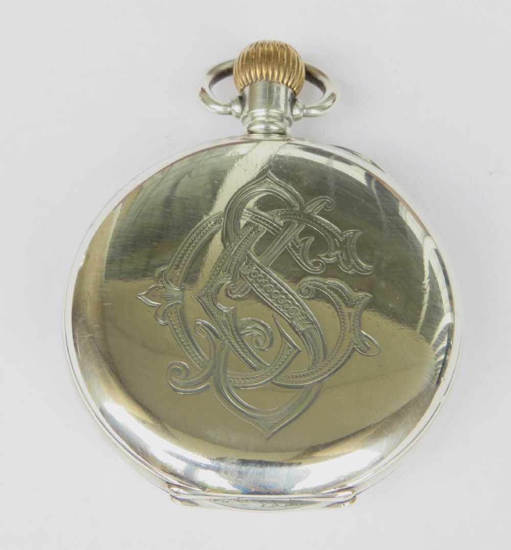 An antique open-face silver pocket watch featuring a white enamel dial with black Roman numerals and a subsidiary seconds dial. View V
