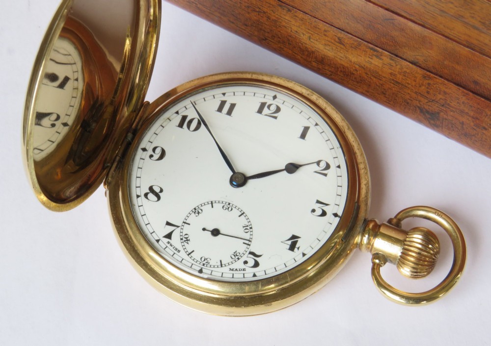 An open vintage gold-plated full hunter pocket watch displaying a white enamel dial with black Arabic numerals and a subsidiary seconds dial. View II