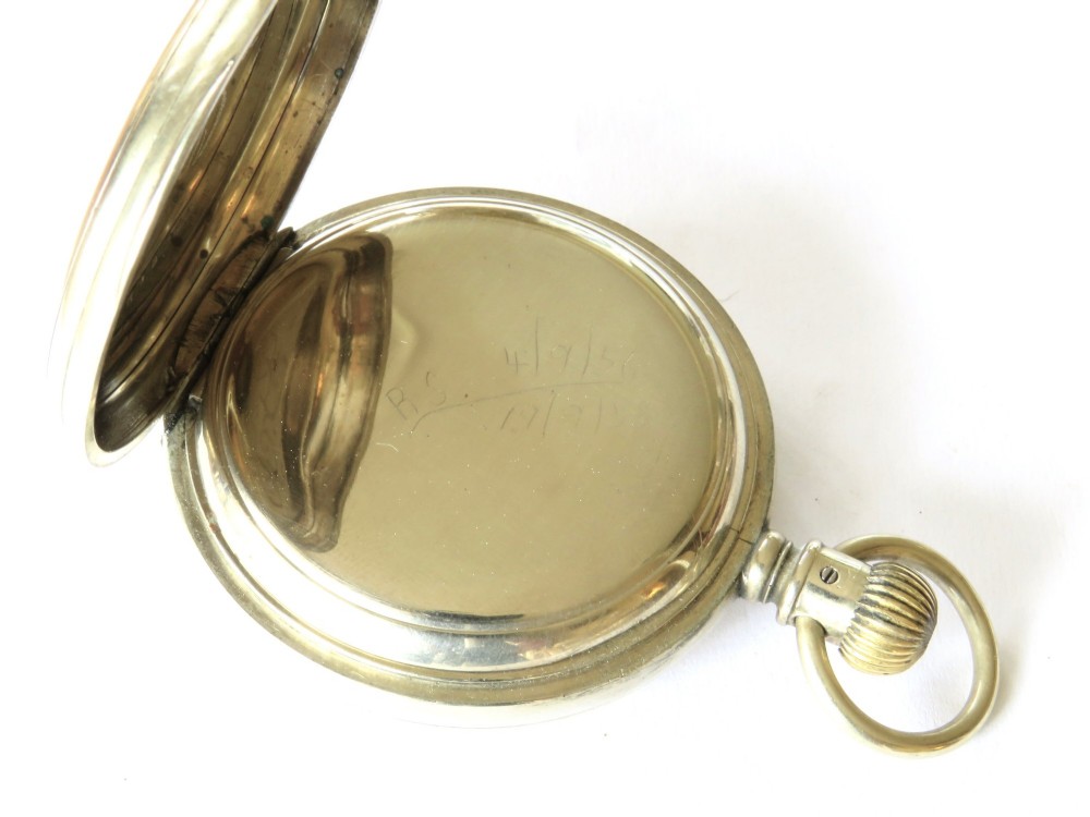 An antique open-face Longines pocket watch with a white enamel Roman numeral dial, connected to a silver-coloured curb chain with an enamelled fob medallion. View V