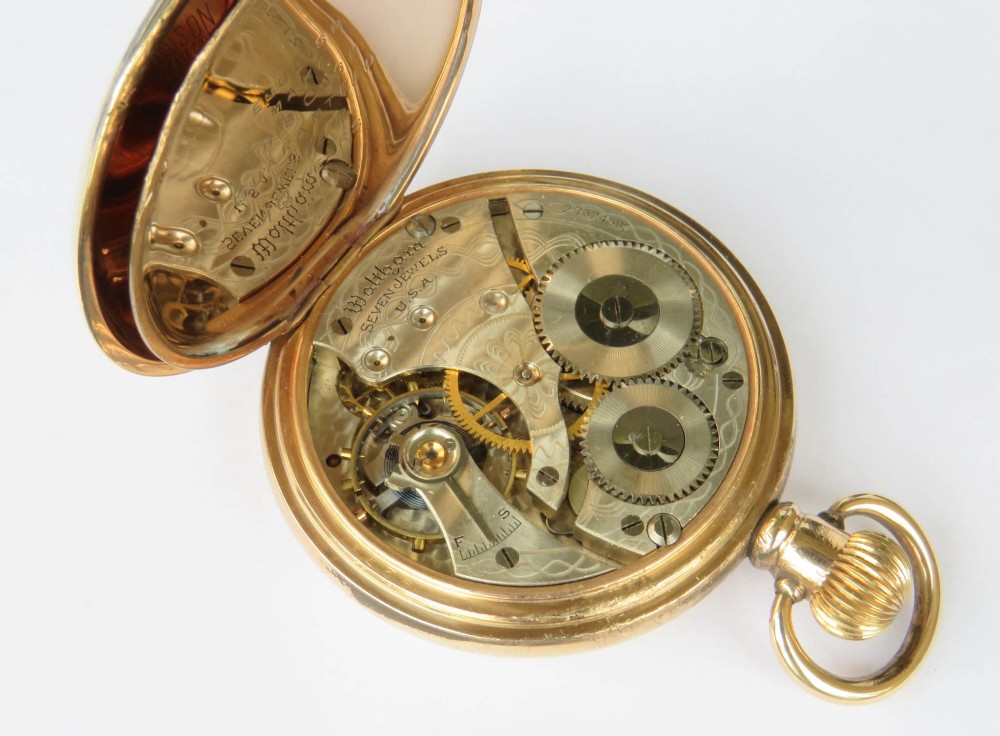 A gold-toned open-face Waltham pocket watch featuring a white enamel dial with black Roman numerals and a sub-seconds dial. View IV