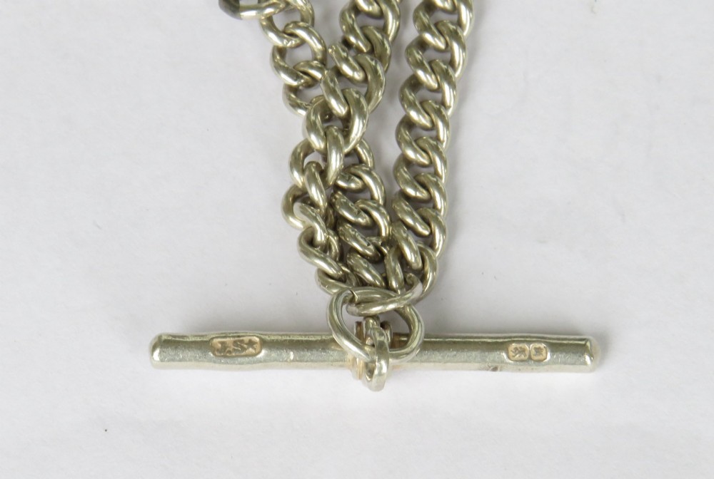 An antique sterling silver single Albert pocket watch chain with curb links, T-bar, swivel clasps, and a central shield-shaped fob. View III