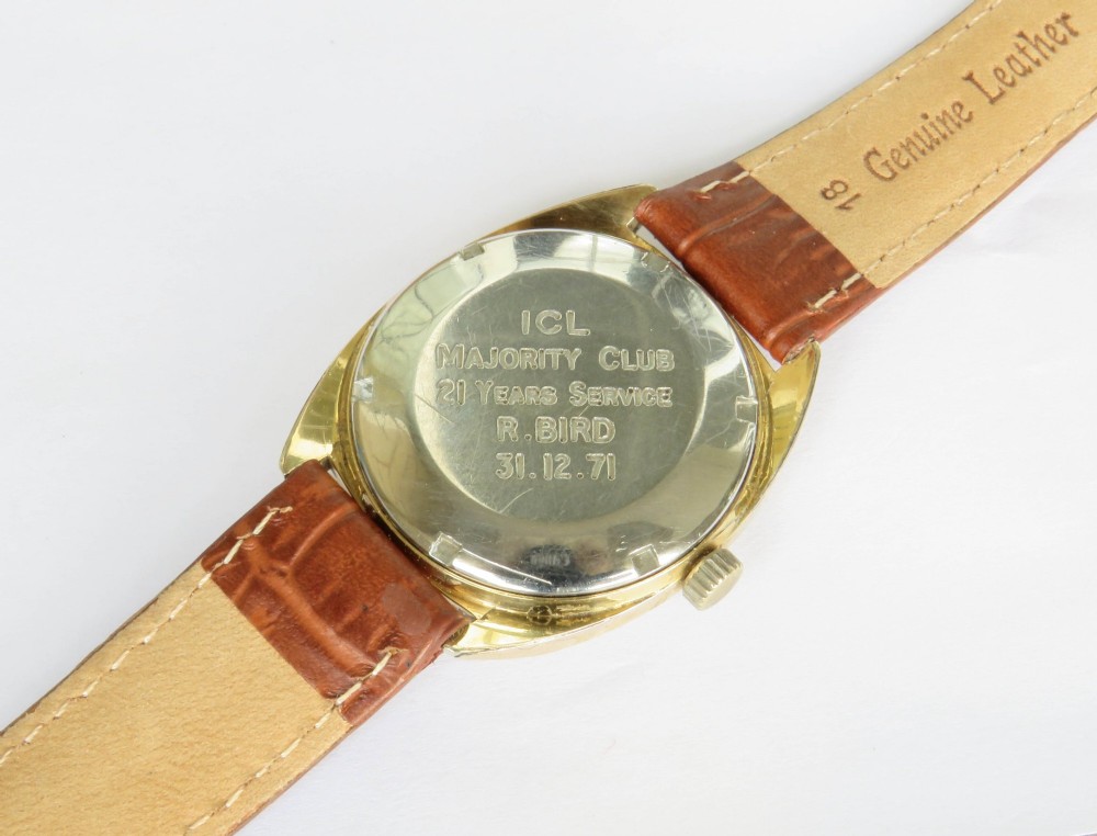 A 1969 gents Eterna-Matic 1000 wristwatch featuring a gold-toned cushion case, champagne dial with date aperture, and brown leather strap. View V