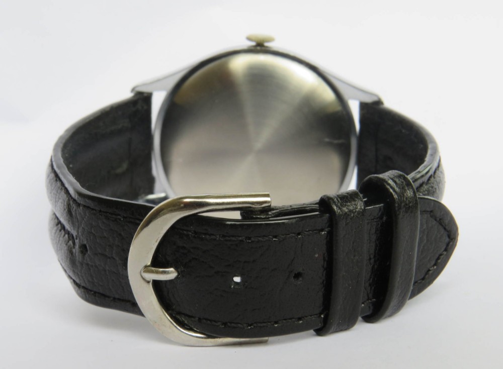 A 1950s Tissot gents wristwatch featuring a cream dial with black Arabic numerals, a sub-seconds subdial at six oclock, a steel case, and a black leather strap. View V