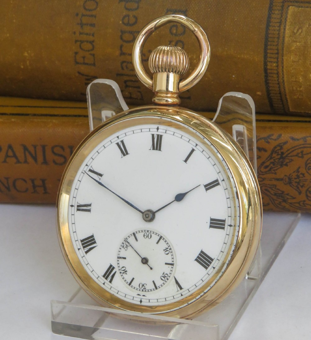 A gold open-face pocket watch featuring a white enamel dial, black Roman numerals, a sub-seconds dial, and blued steel hands.