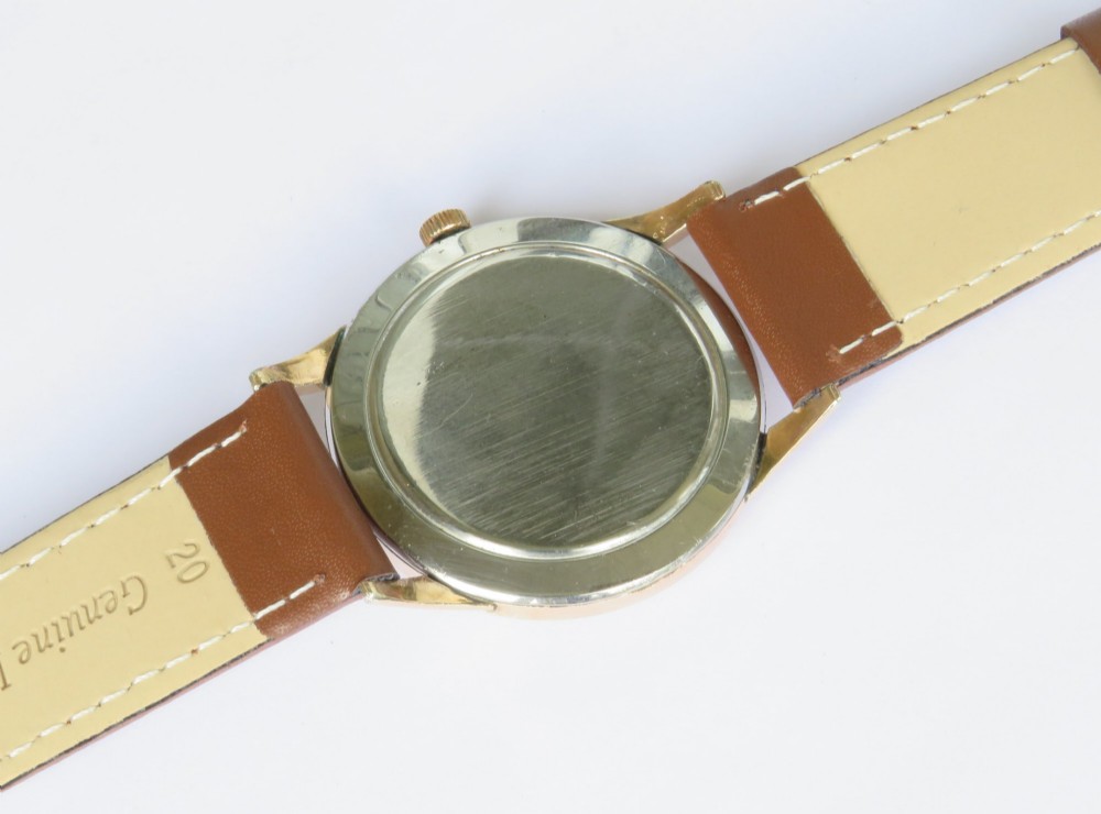A 1950s Gents Wyler-Vetta wristwatch featuring a gold-toned circular case, cream textured dial with sub-seconds subdial, and a brown leather strap. View III