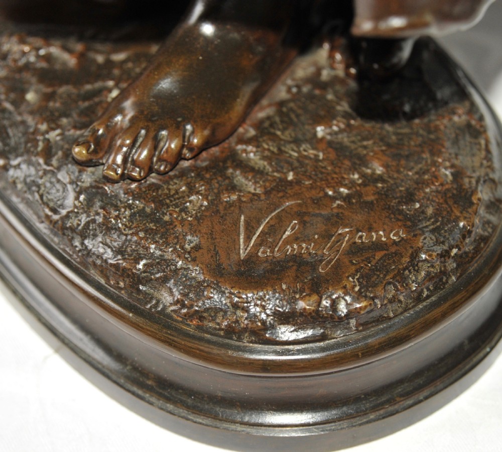 A nineteenth-century patinated bronze sculpture depicting a standing peasant girl holding a tambourine on an integral base. View V