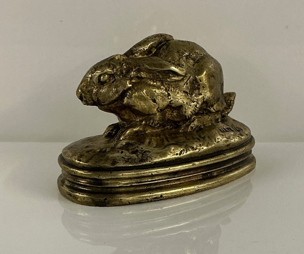 A small 19th-century gilt bronze sculpture depicting a crouching rabbit on an oval moulded base. View IV